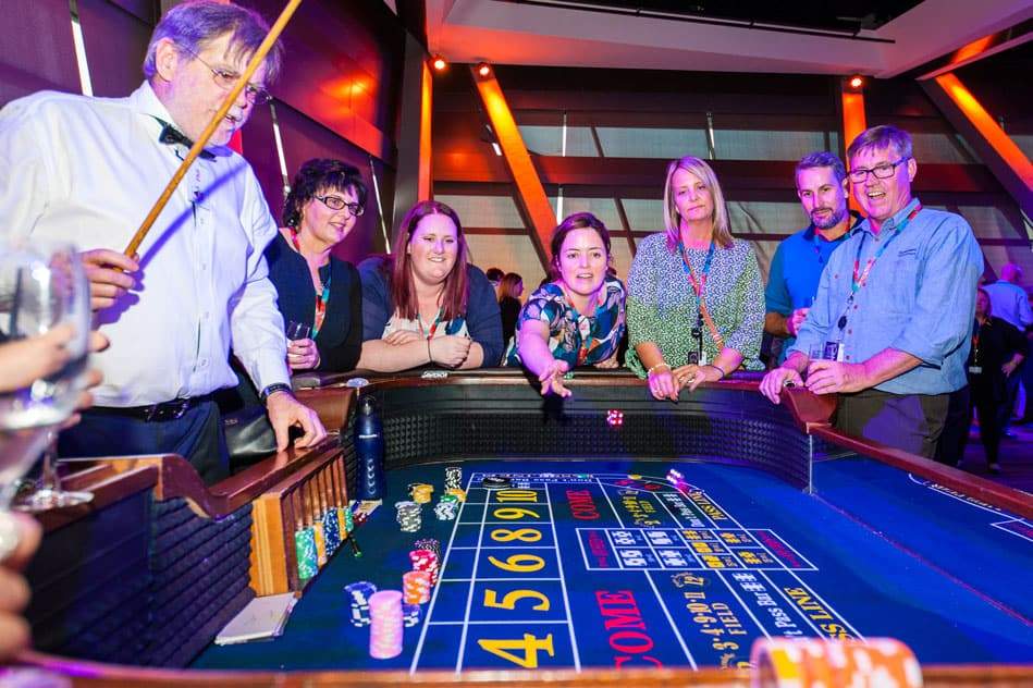 People playing craps at a conference welcome event.